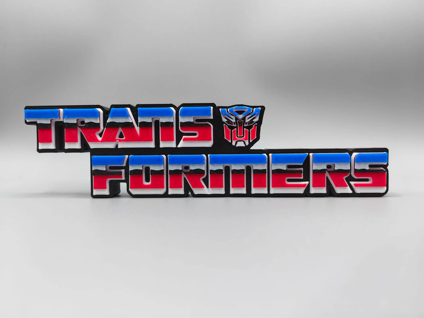 Targa Transformers con logo Autobot rosso e blu — Decorazione da scrivania con supporto tridimensionale