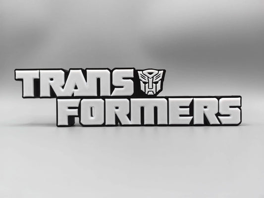 Targa Transformers con logo argentato monocromatico — Decorazione da scrivania con finitura metallizzata