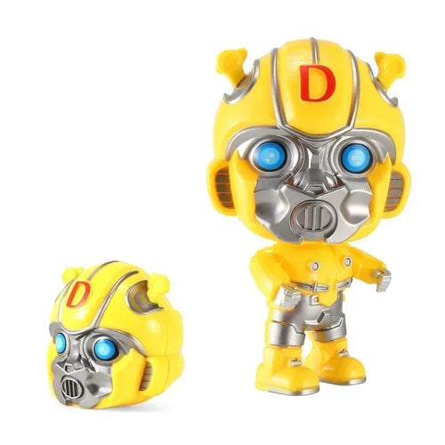 Figurine robot jaune style cartoon, tête détachable, yeux bleus lumineux, sur fond blanc – Transformers.